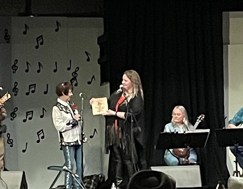 Misty Dawn receiving a plaque honoring her years of service to the Music Culture of Fremont County